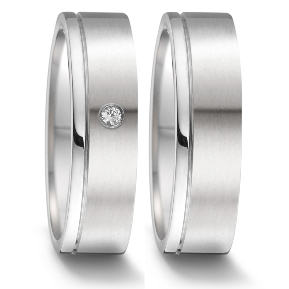 Partnerring Willkommen, meine Damen, auf der Suche nach dem perfekten Partnerring? Suchen Sie nicht weiter! Unser Partnerring aus Edelstahl mit einem Diamanten von 0,02 Karat (tw-si), hergestellt in Deutschland, ist das perfekte Accessoire für jeden besonderen Anlass. Mit seinem klassischen und zeitlosen Design können Sie sicher sein, ein besonderes Schmuckstück zu besitzen, das ein Leben lang hält. Sichern Sie sich Ihren noch heute! 069.1312.D58.XX